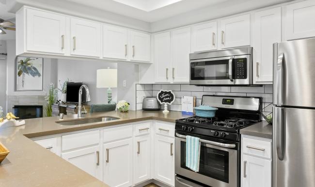 a kitchen with white cabinets