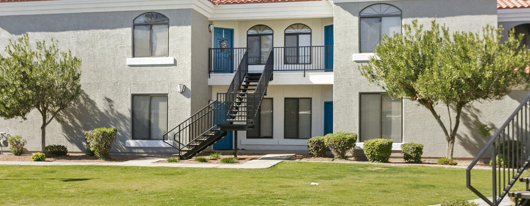 a building with a staircase and trees