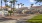 a building with palm trees and grass