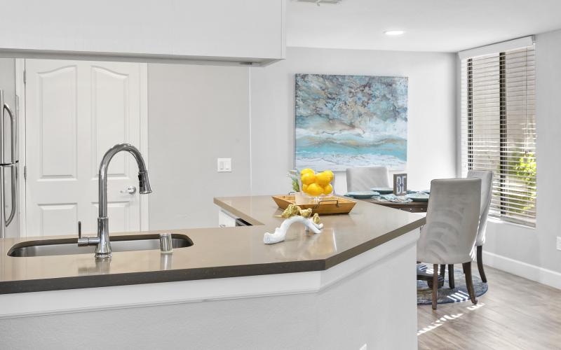 a kitchen with a painting on the wall
