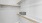 a white room with a metal shelf